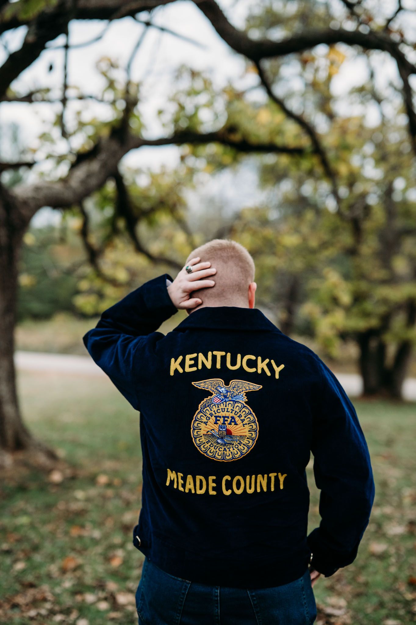 Back view of Mayson wearing his FFA jacket at his Meade County senior session