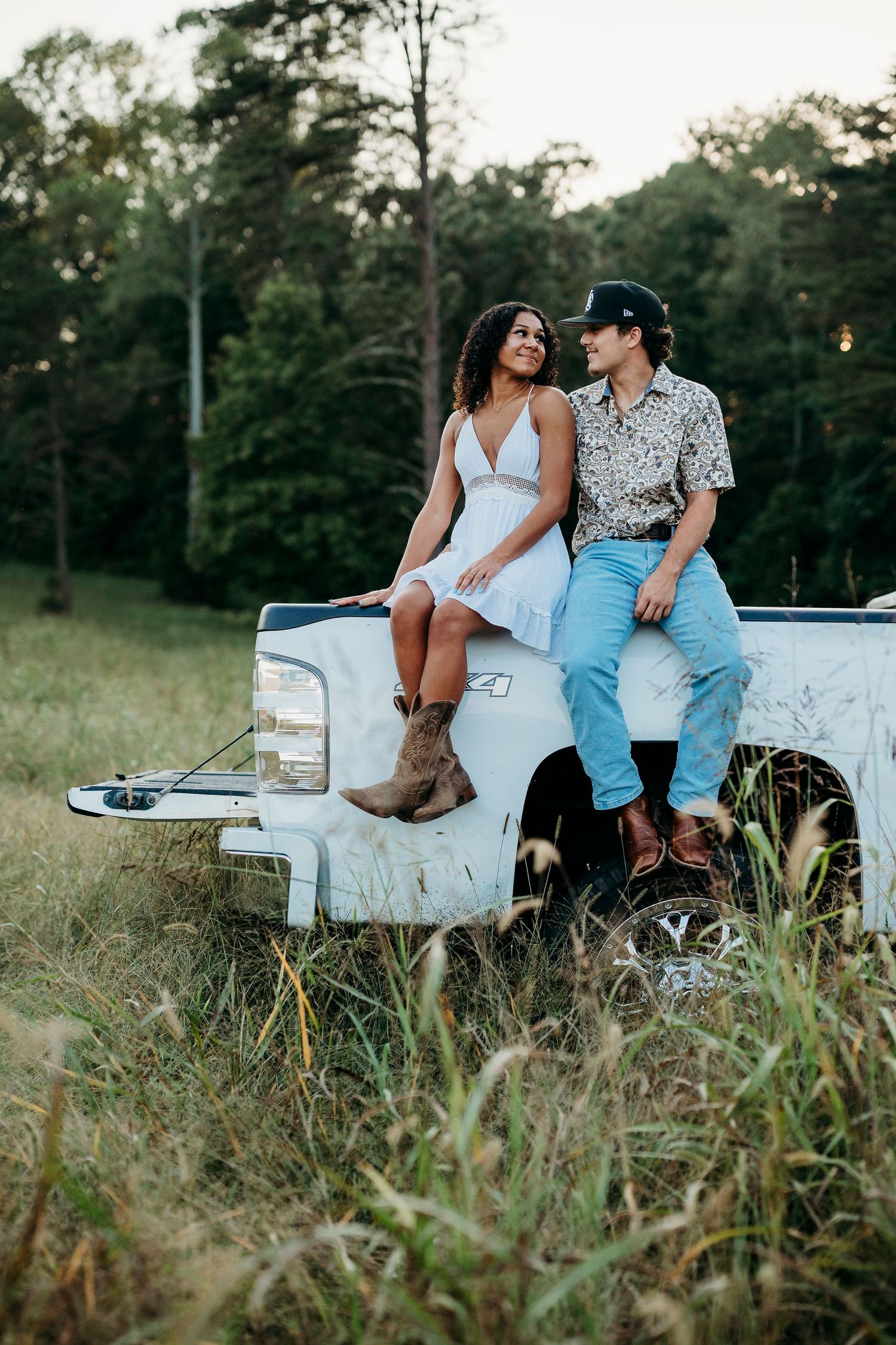 Fun senior session in Brandenburg KY with barefoot Bella laughing on truck tailgate by ninefifteenphoto