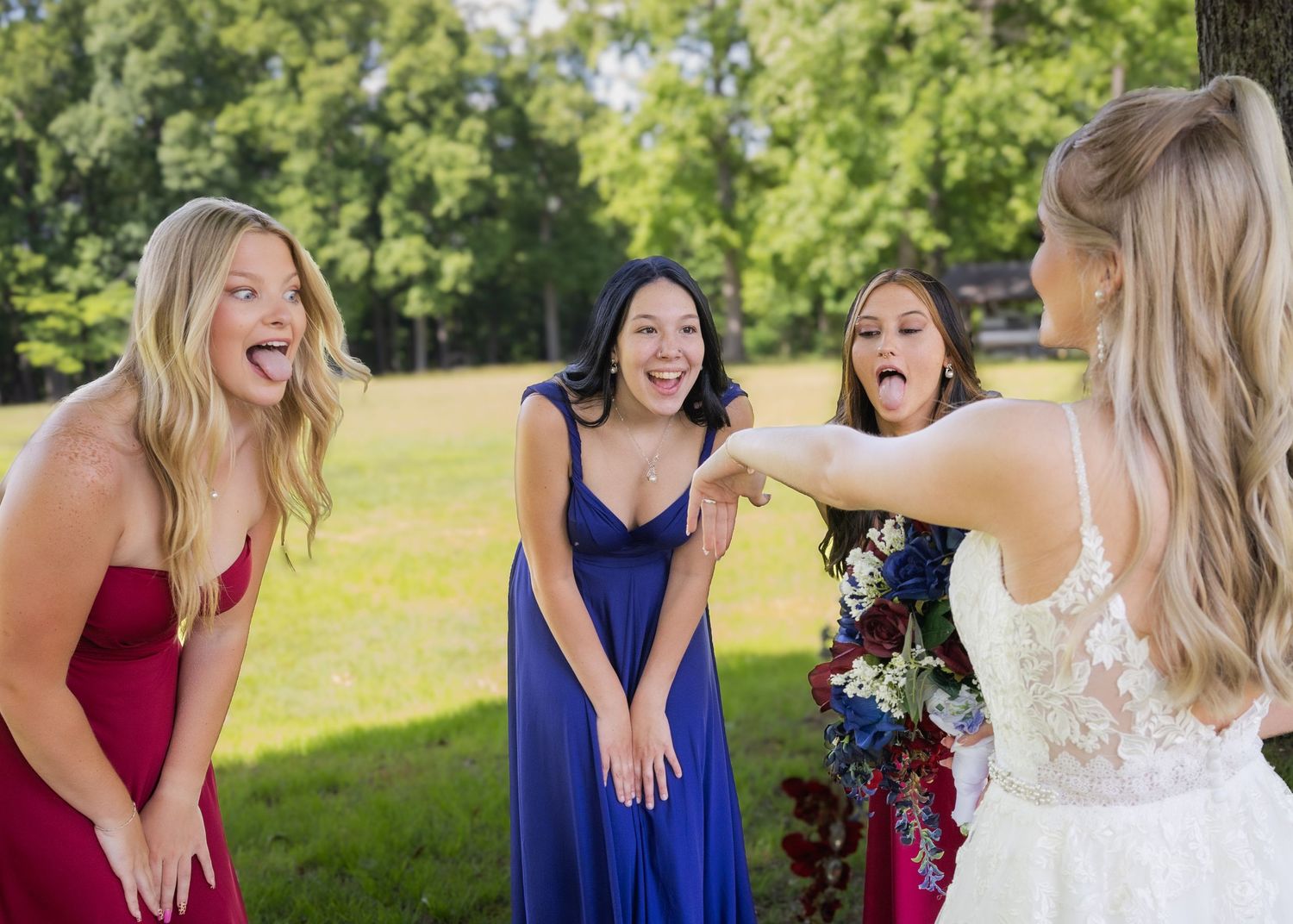 Bride surprises bridesmaids in colorful gowns with joyful reactions outdoors at a wedding celebration.