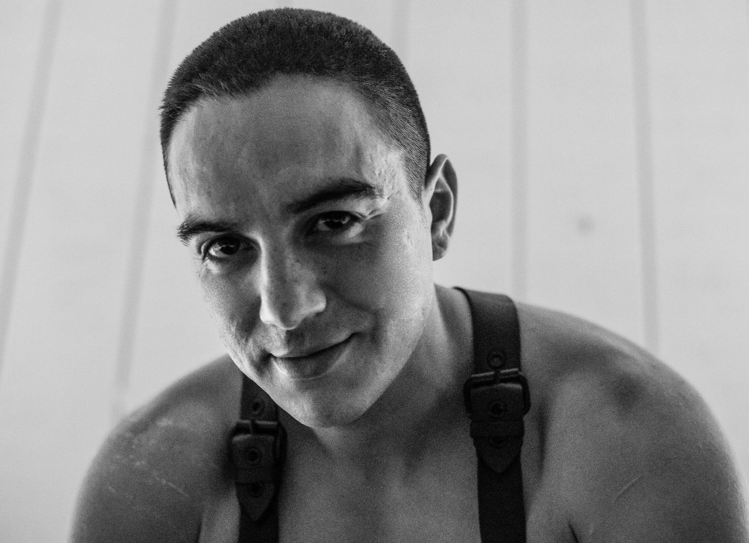 Series of black and white portraits with minimalist white background.