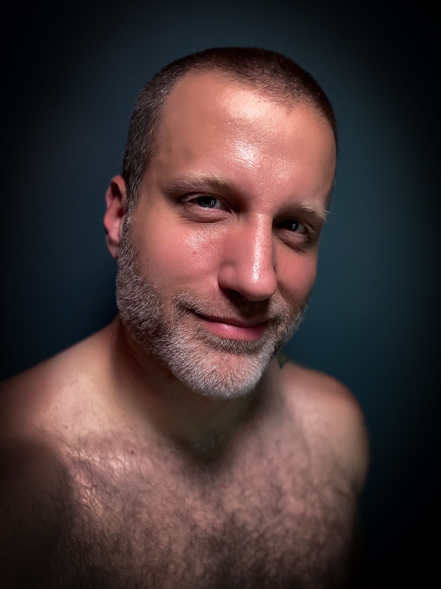 Intimate portrait series with warm lighting against blue backdrop showing different angles and expressions.