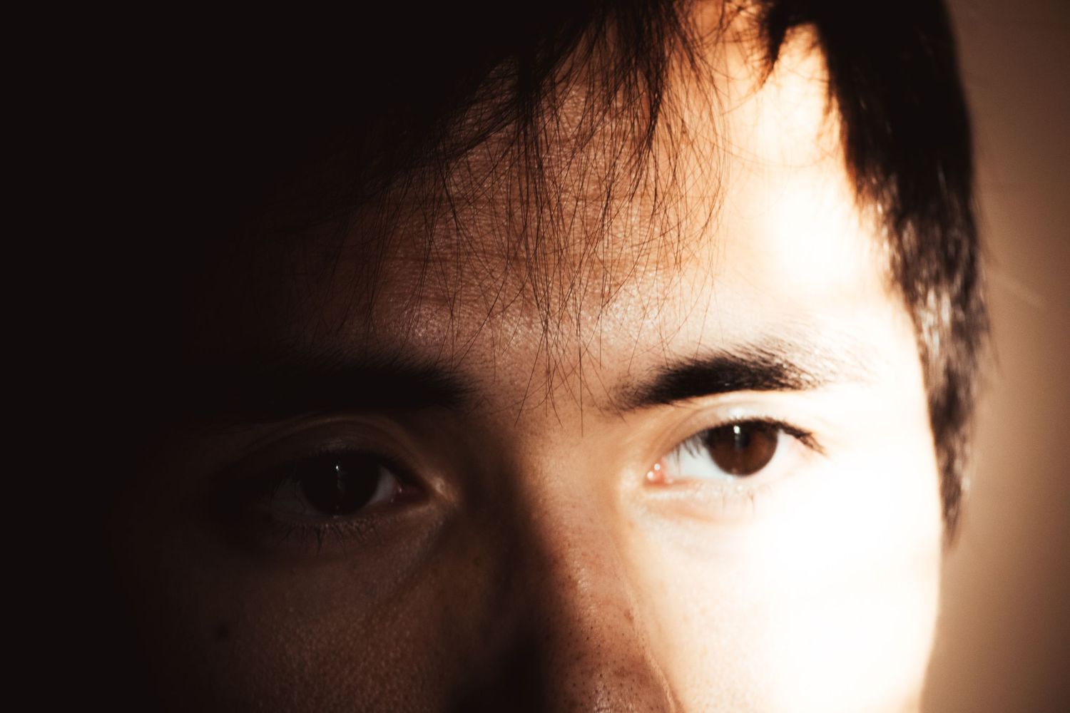 Close-up shots focusing on eyes and facial features in dramatic lighting.