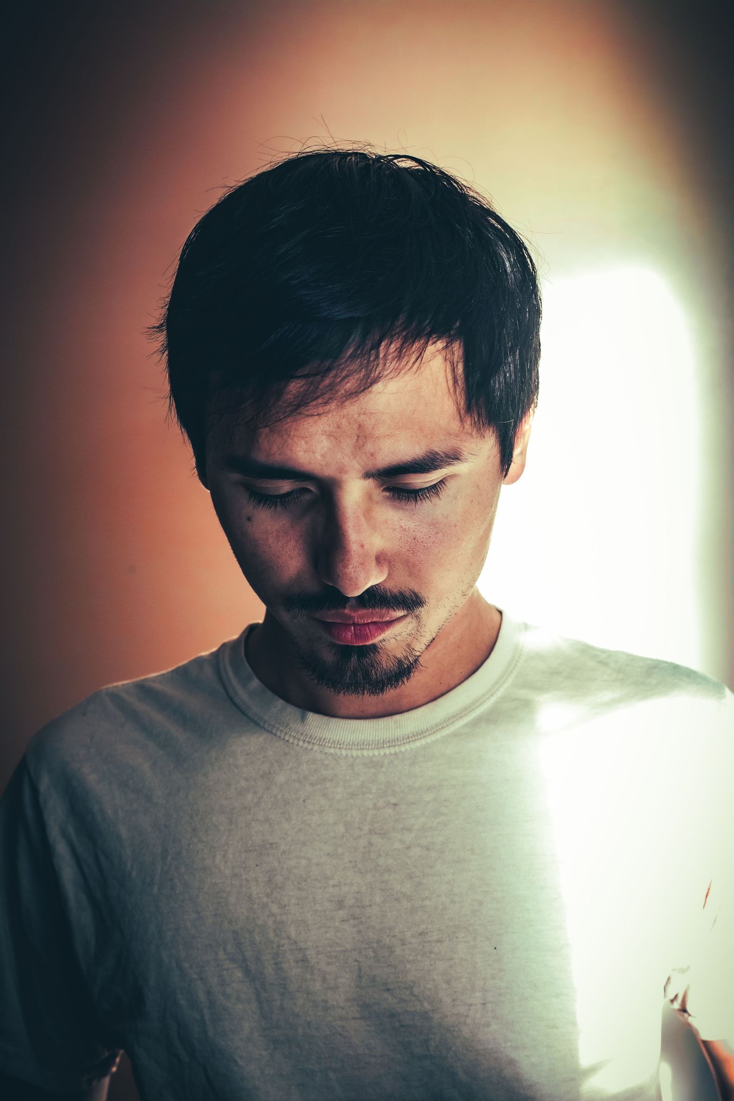 Portrait series showing person in white shirt with warm lighting effects.