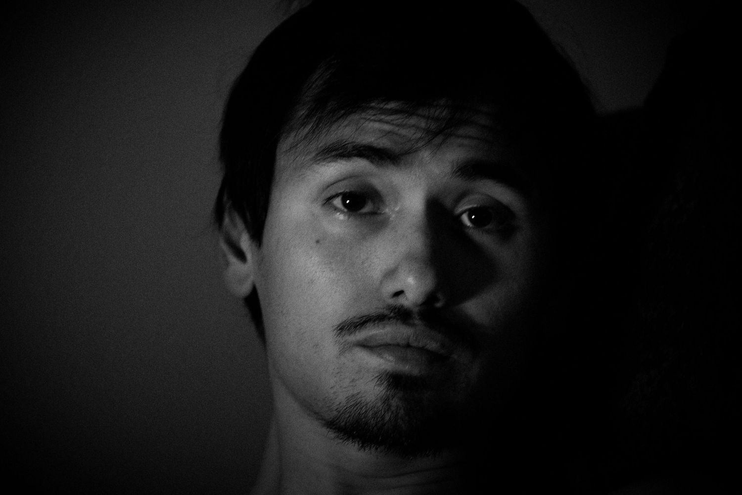 Series of black and white close-up portraits with dramatic side lighting creating shadow contrast.