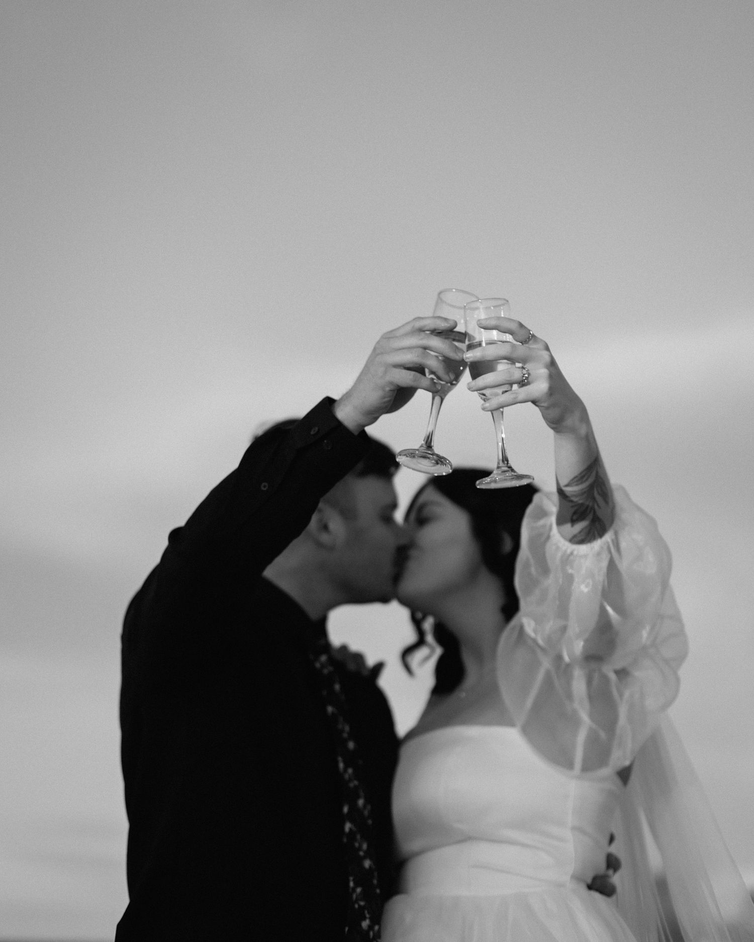 A series of black and white wedding photos showing intimate moments between a couple during their celebration.