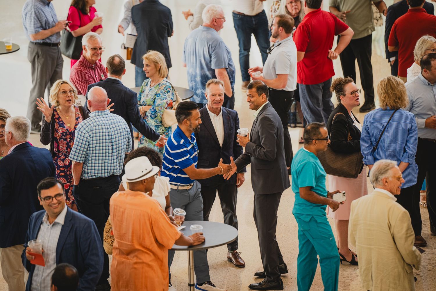 Diverse group of attendees socializing during a professional networking event.