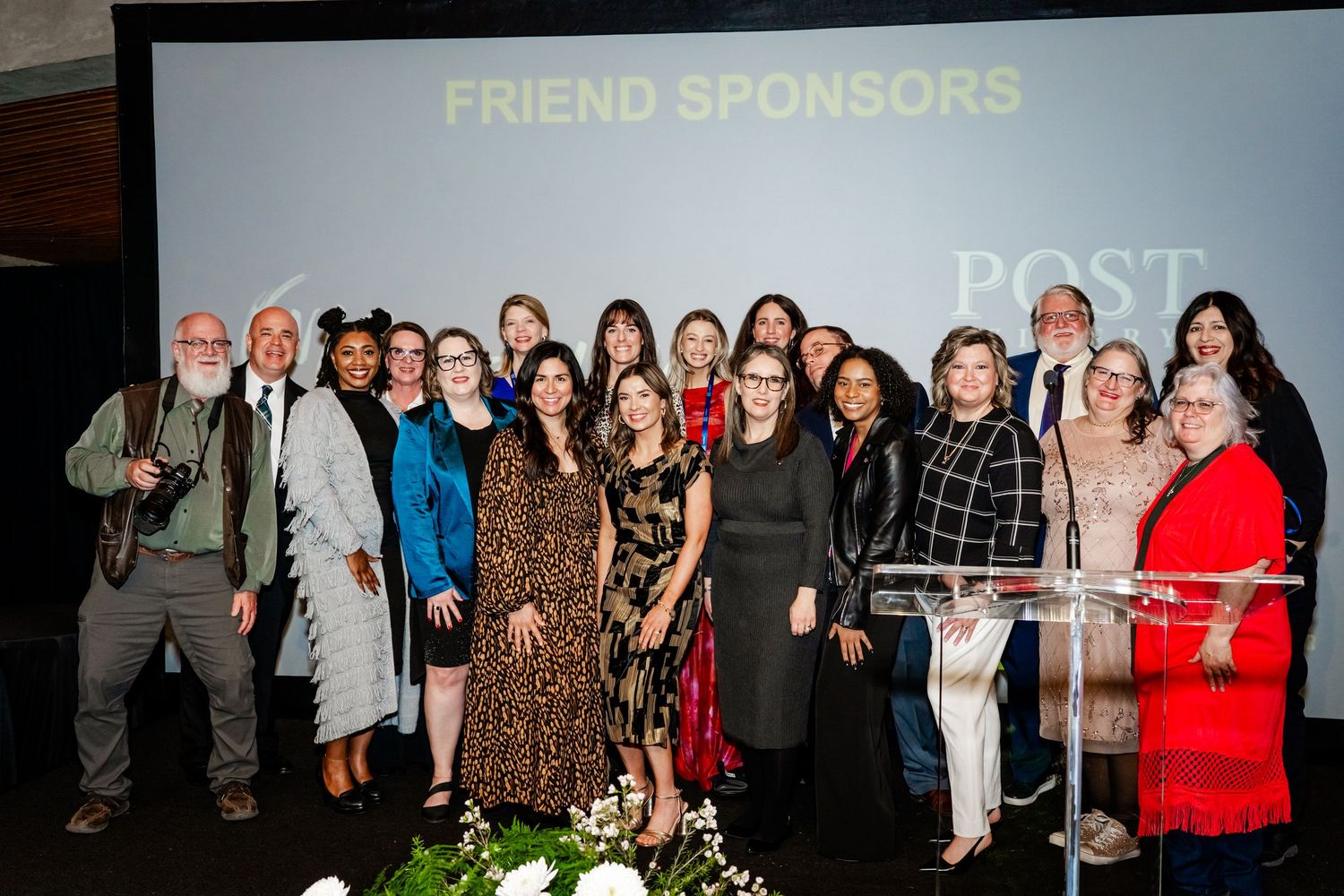 Sponsor banners and logos displayed at a formal fundraising event.