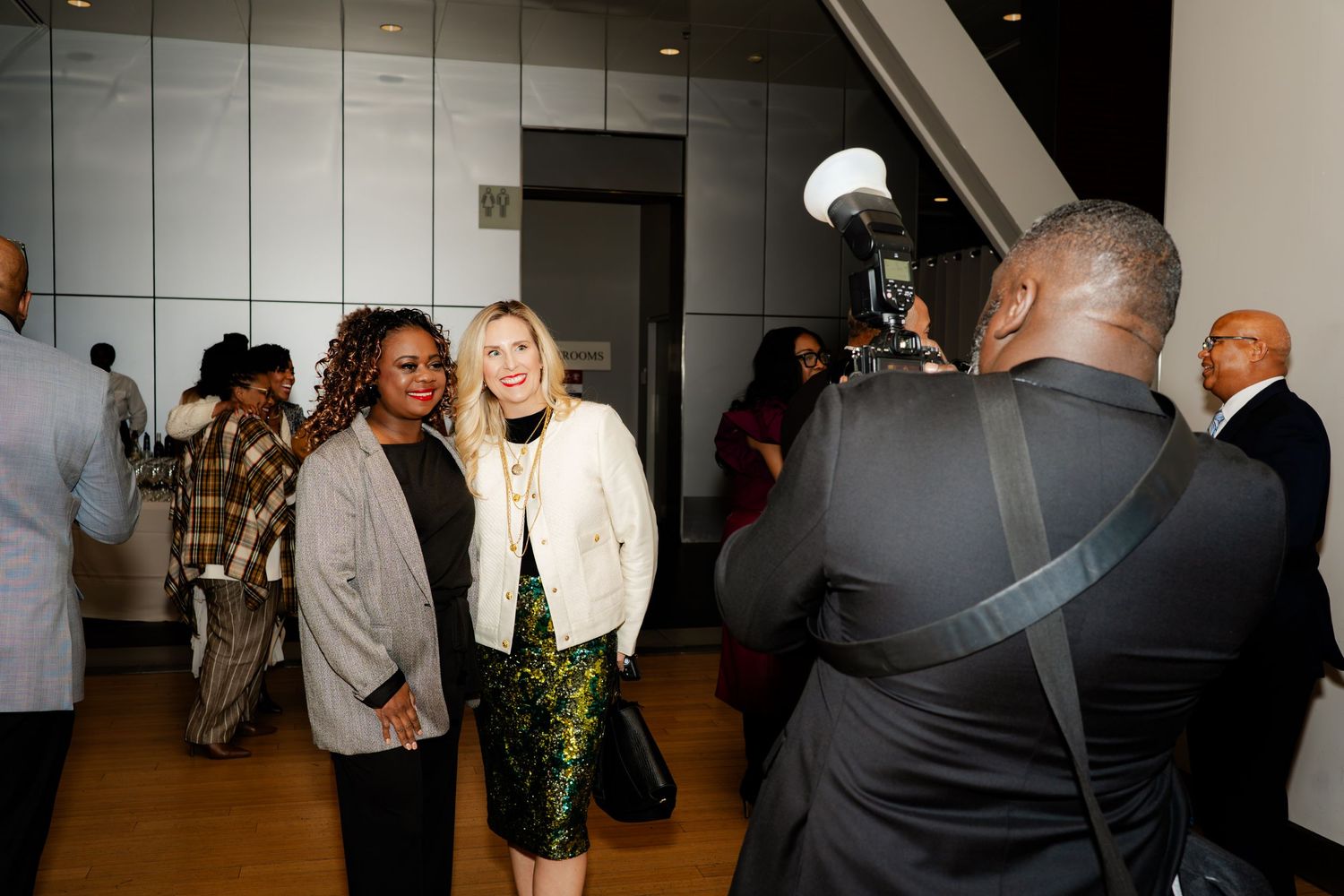 Photographer capturing shots of guests at an indoor event.