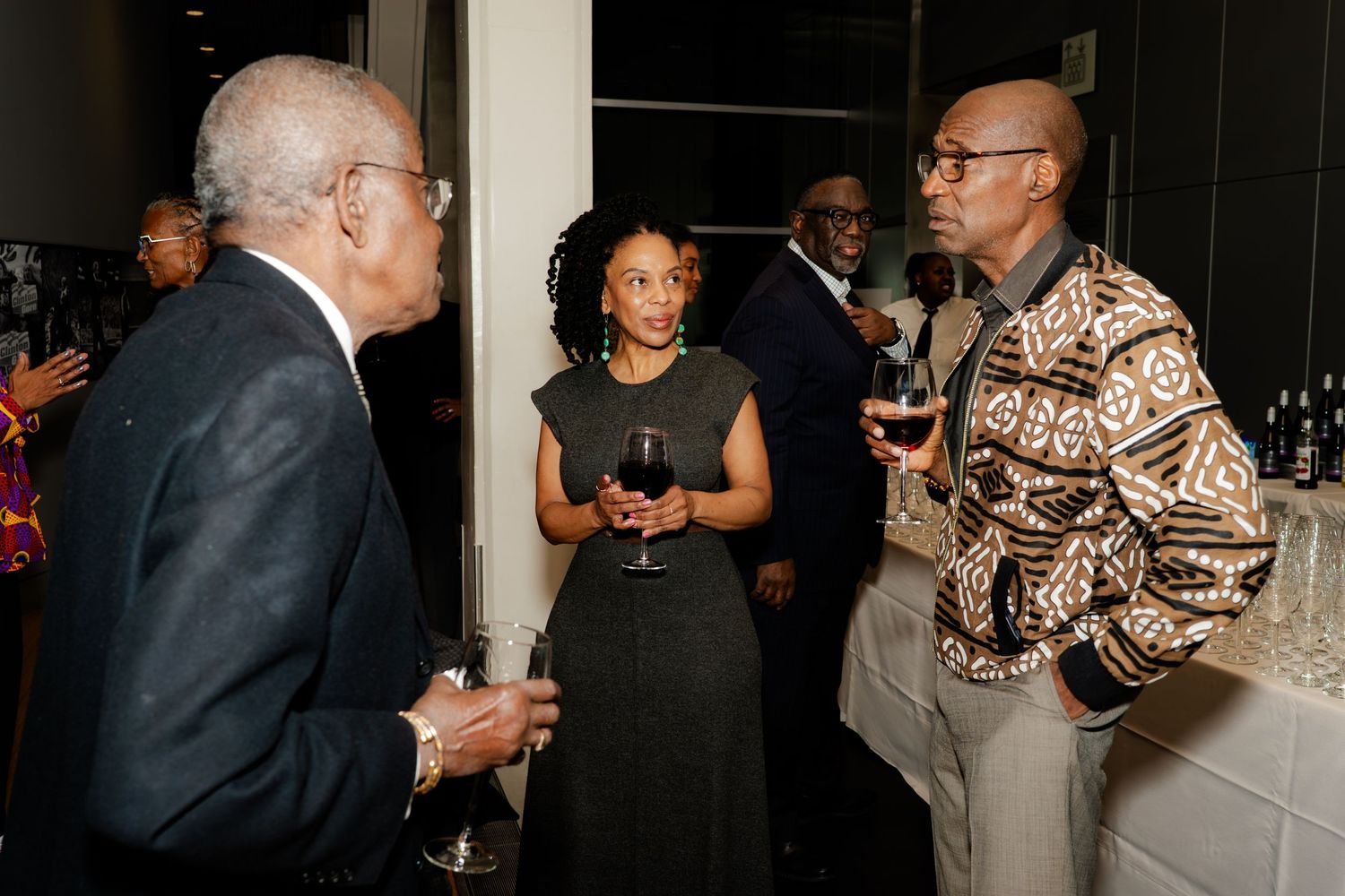 Group engaged in conversation at an evening social event.