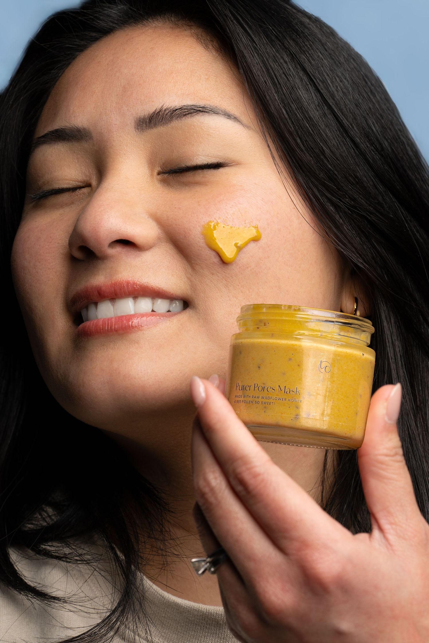 Beauty product demonstration showing yellow cream application on skin in multiple steps.