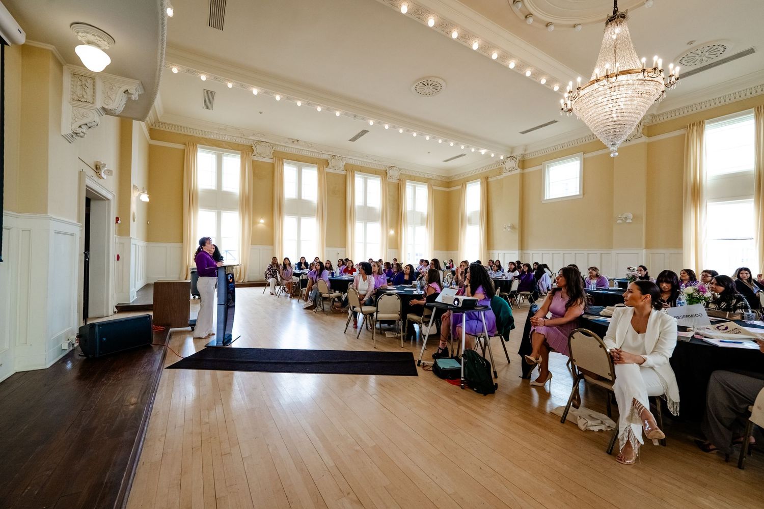 Large banquet hall set up with round tables and chairs for a formal event.