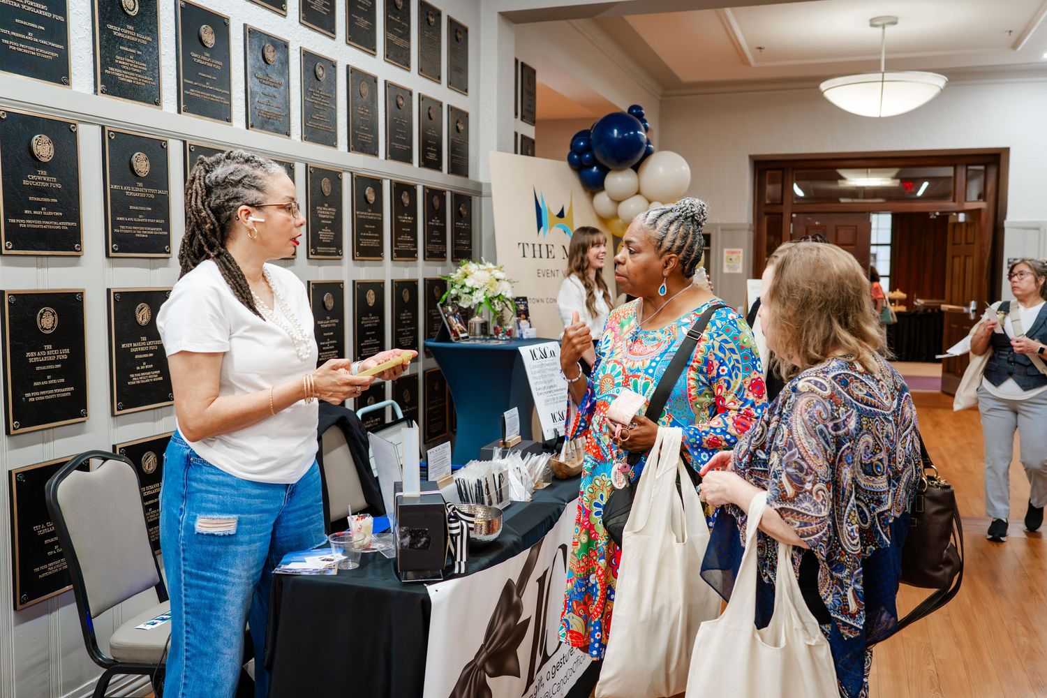 Exhibition hall filled with vendor booths and displays along the walls.