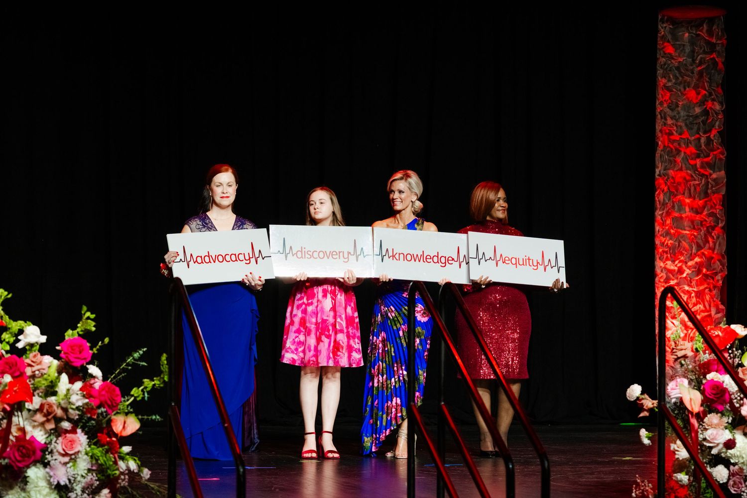 Stage performance with colorful dresses and lighting at fundraising gala show.