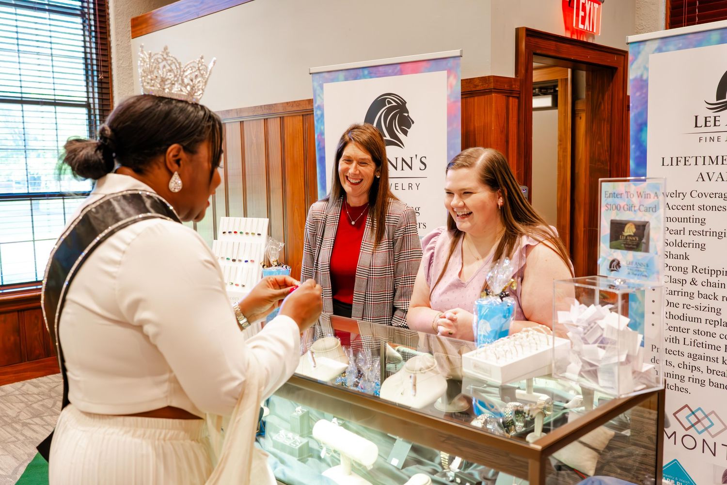 Visitors explore product displays and information booths at an indoor exhibition.