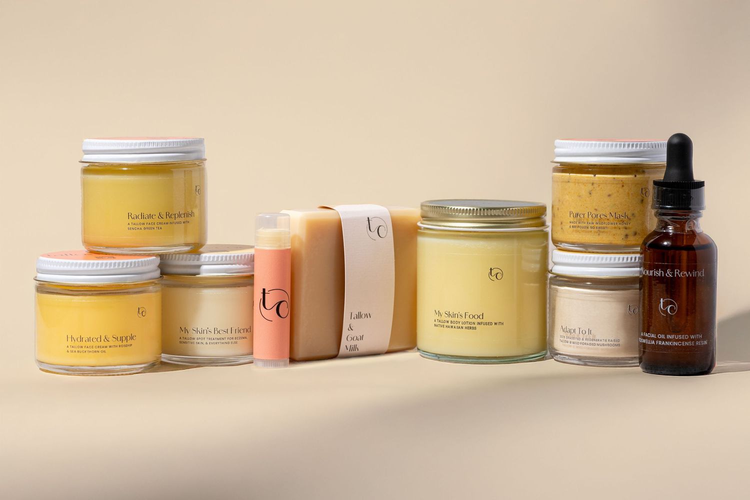 Beauty product flatlay featuring various cream jars and containers on neutral background.