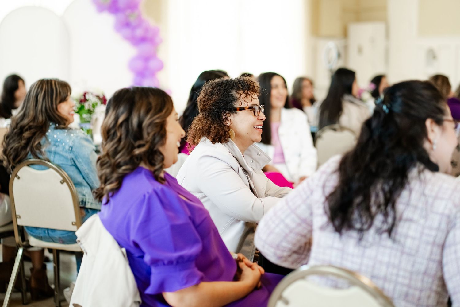 Women participating in professional development workshop at indoor venue.