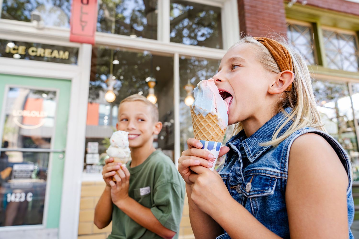 Friends enjoying ice cream together outside an ice cream shop.