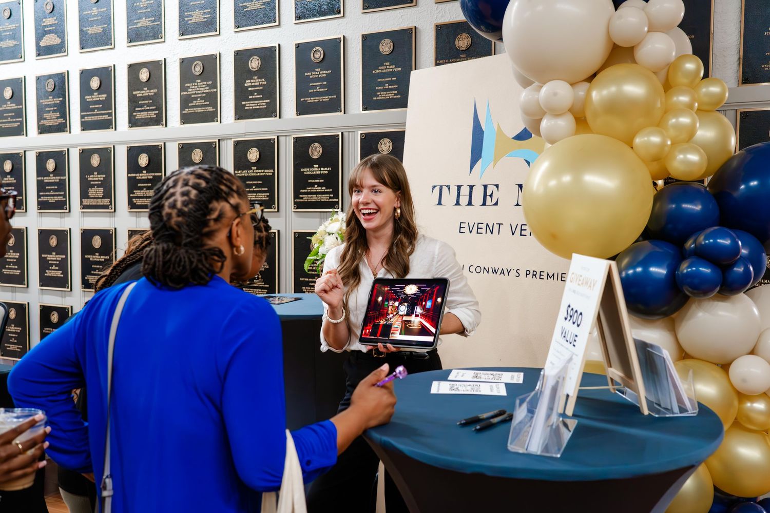 Wall display with numbered plaques and balloon decorations in blue and gold colors.