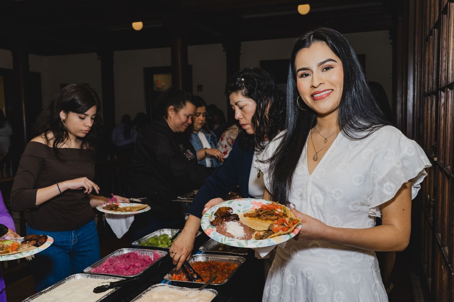 Attendees enjoying food and conversation at a networking event.