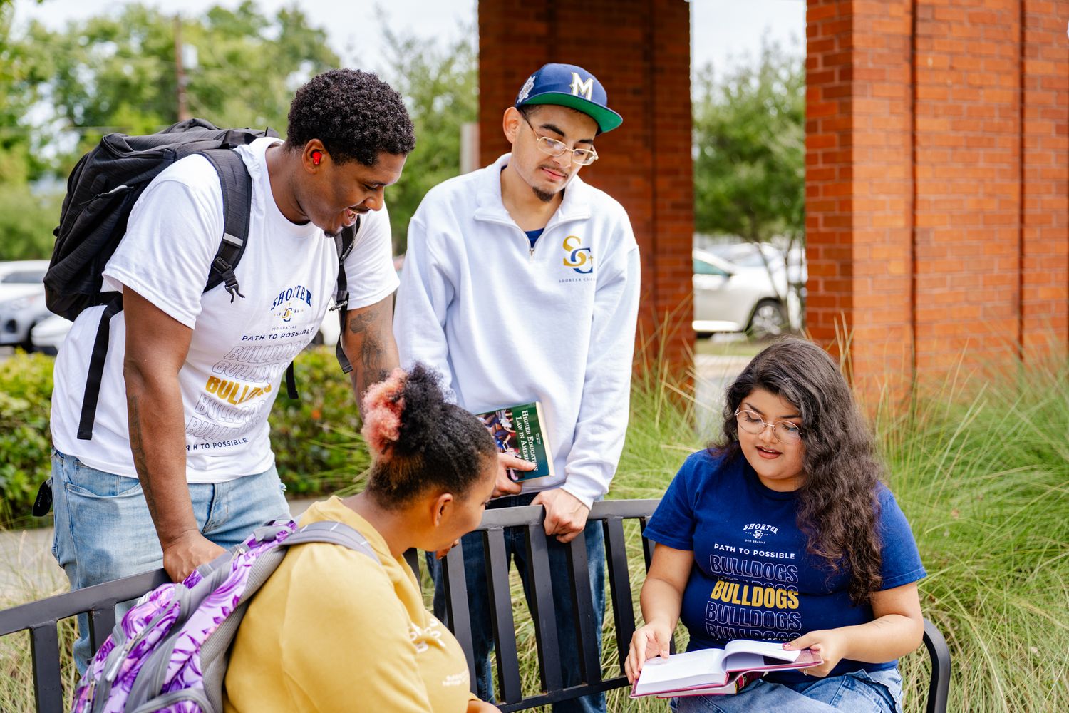 Group of students collaborating outdoors on a sunny day.