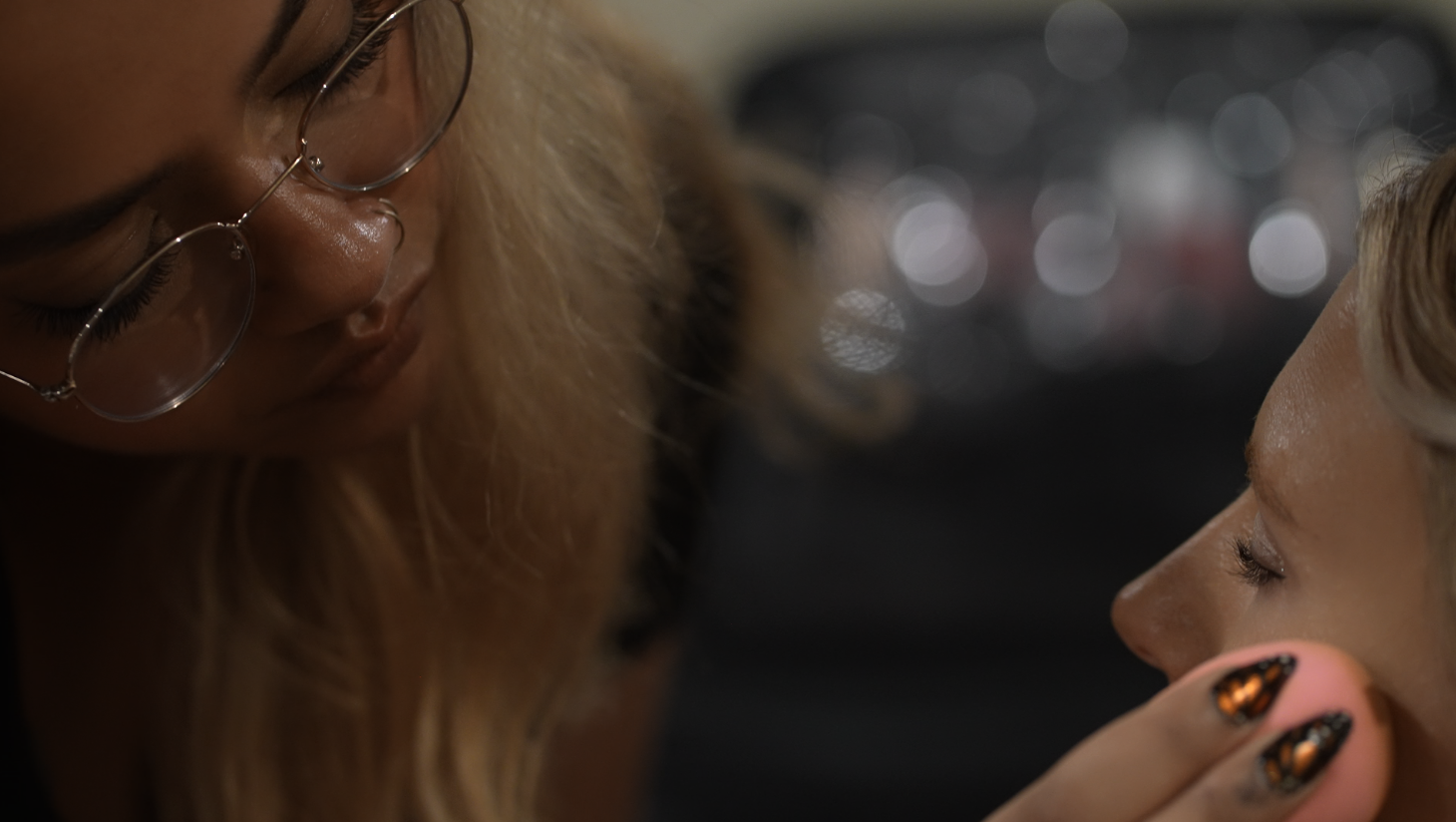 Close-up profile shot in dim lighting with glasses visible. primp beauty. glamour and fashion.