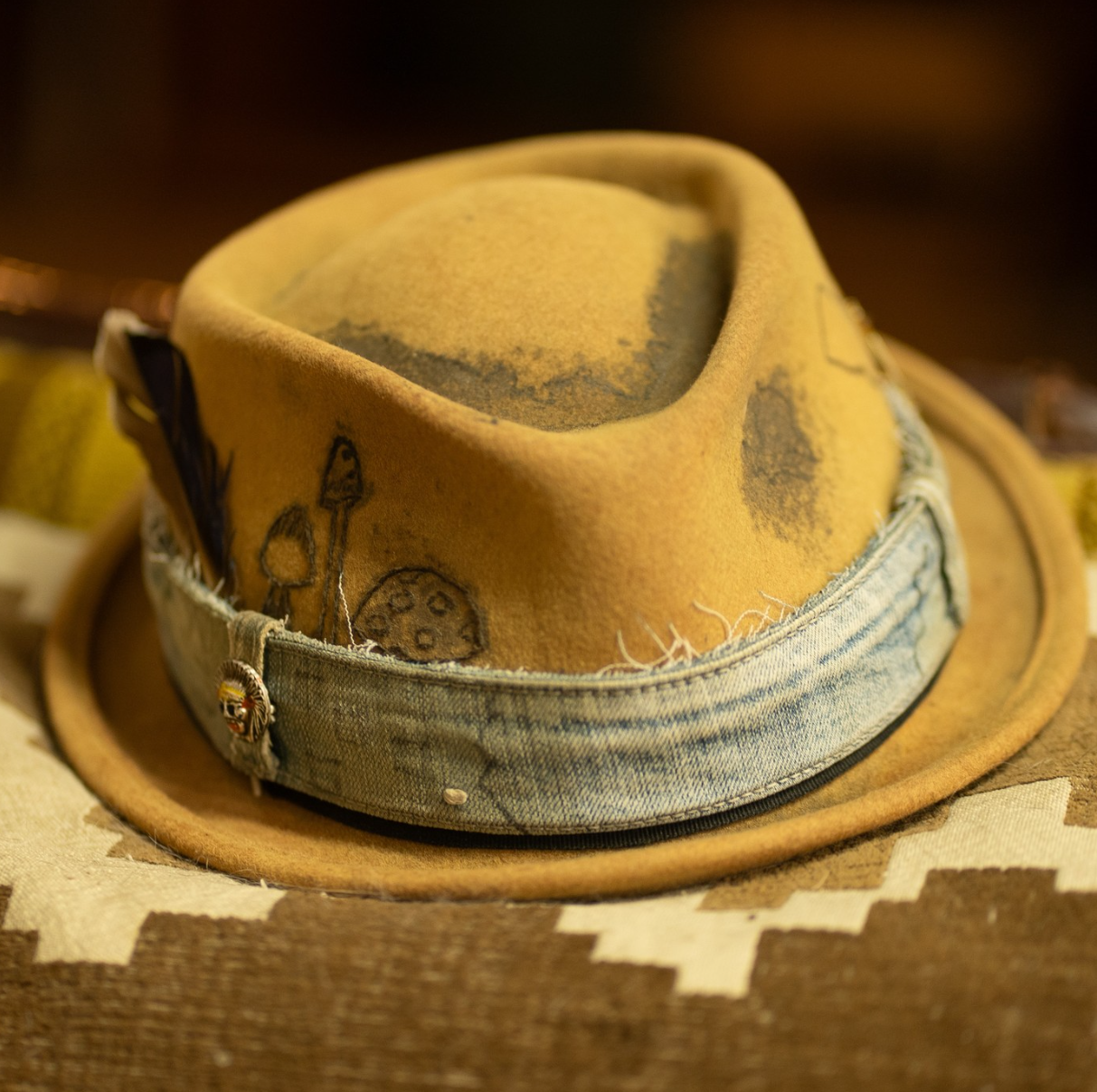 Close-up of weathered brown hat brim with vintage texture and wear patterns. Stilart. Spread the inner love. Ben Suydam. Michigan artist.