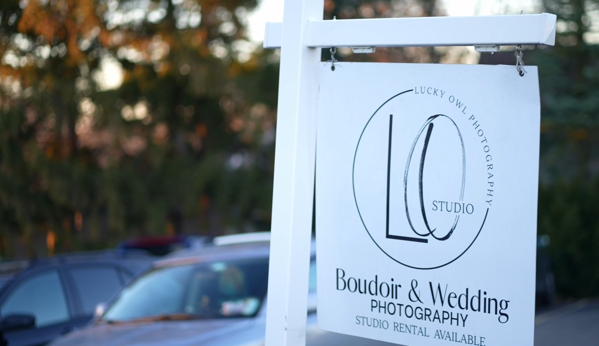 Wedding photography business sign mounted outdoors. lucky owl studio