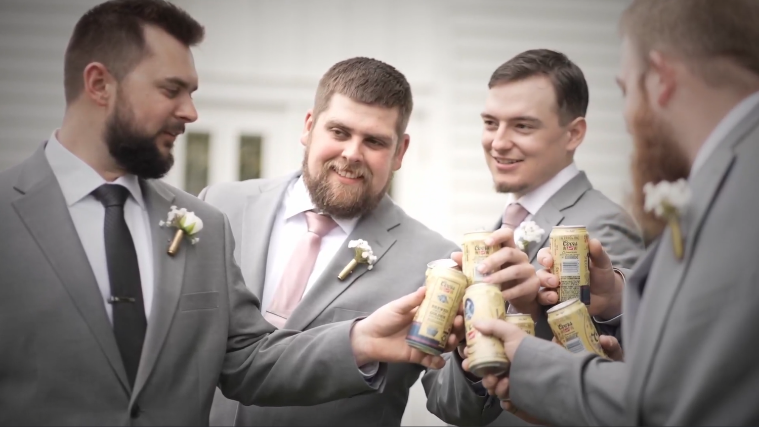 Groomsmen sharing drinks and toasting at wedding celebration.
wedding celebration. cheers.