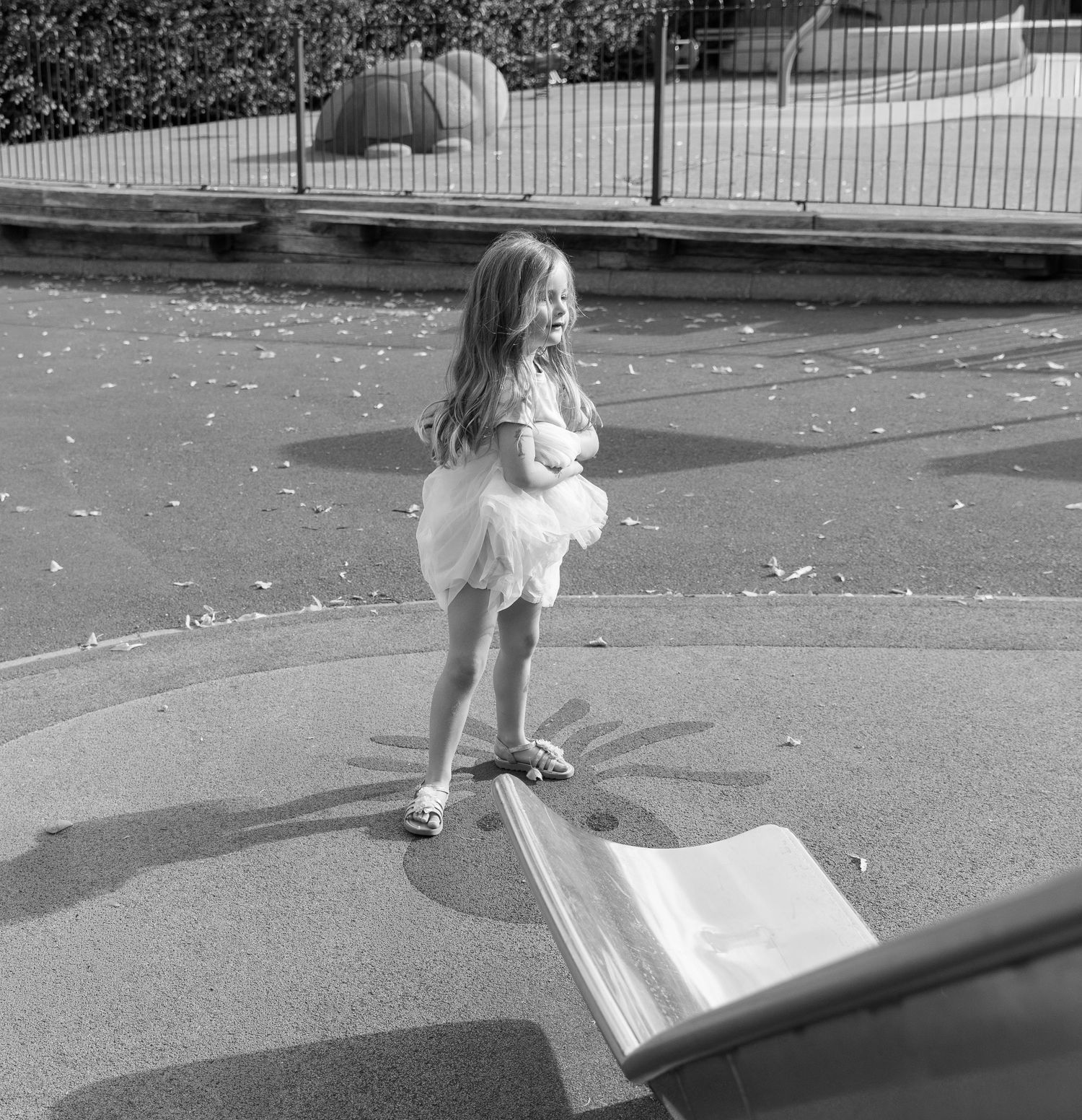 A sequence of black and white photos showing someone playing in the playground.
