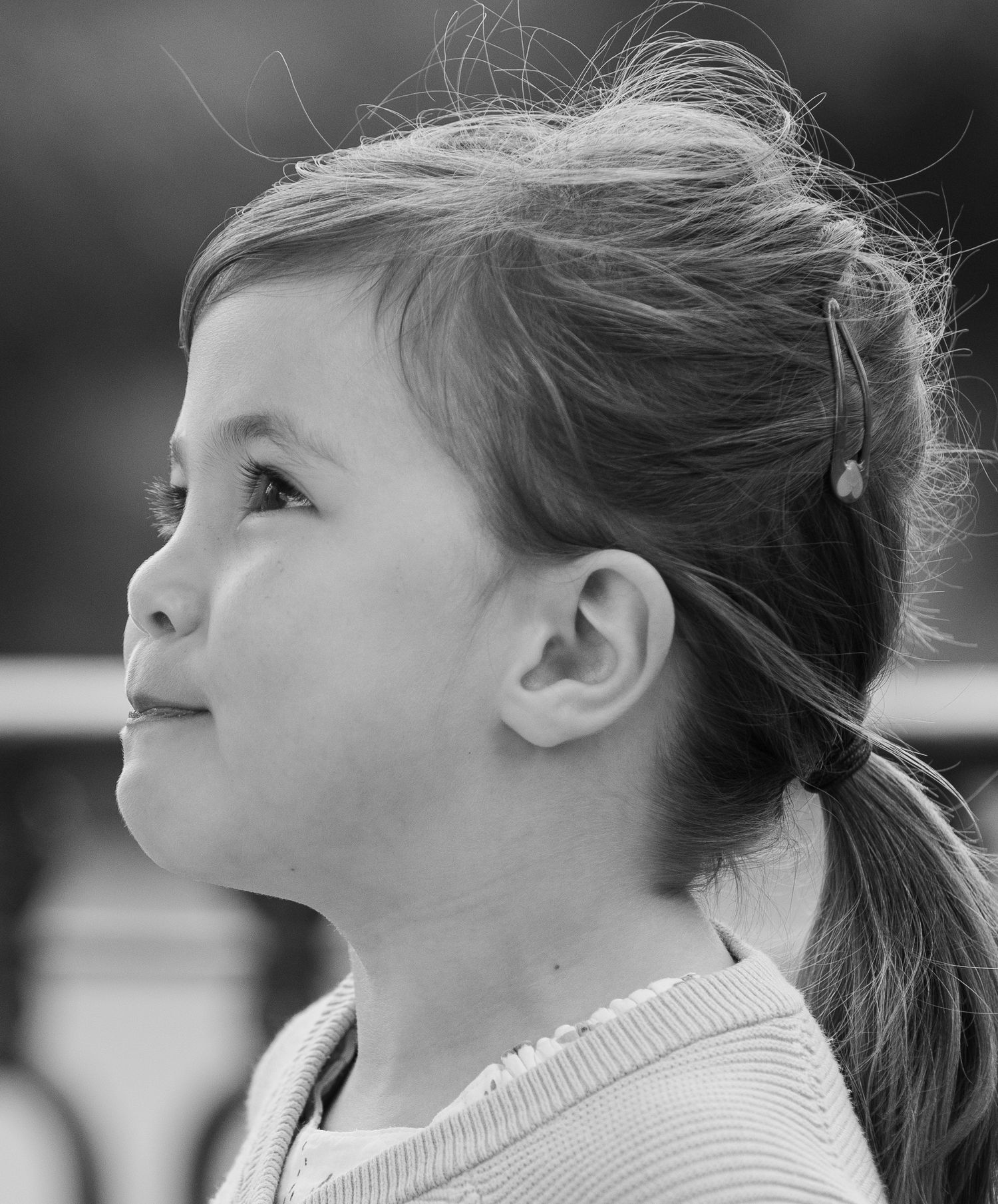 Profile view in black and white showing expressions of joy and wonder.