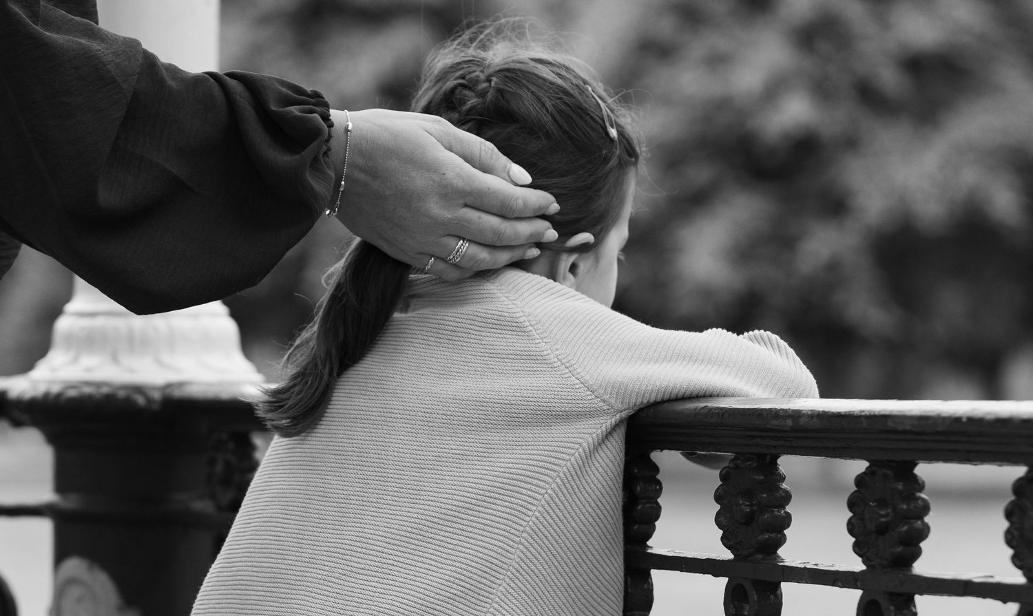 Black and white candid photo capturing intimate moments outdoors.