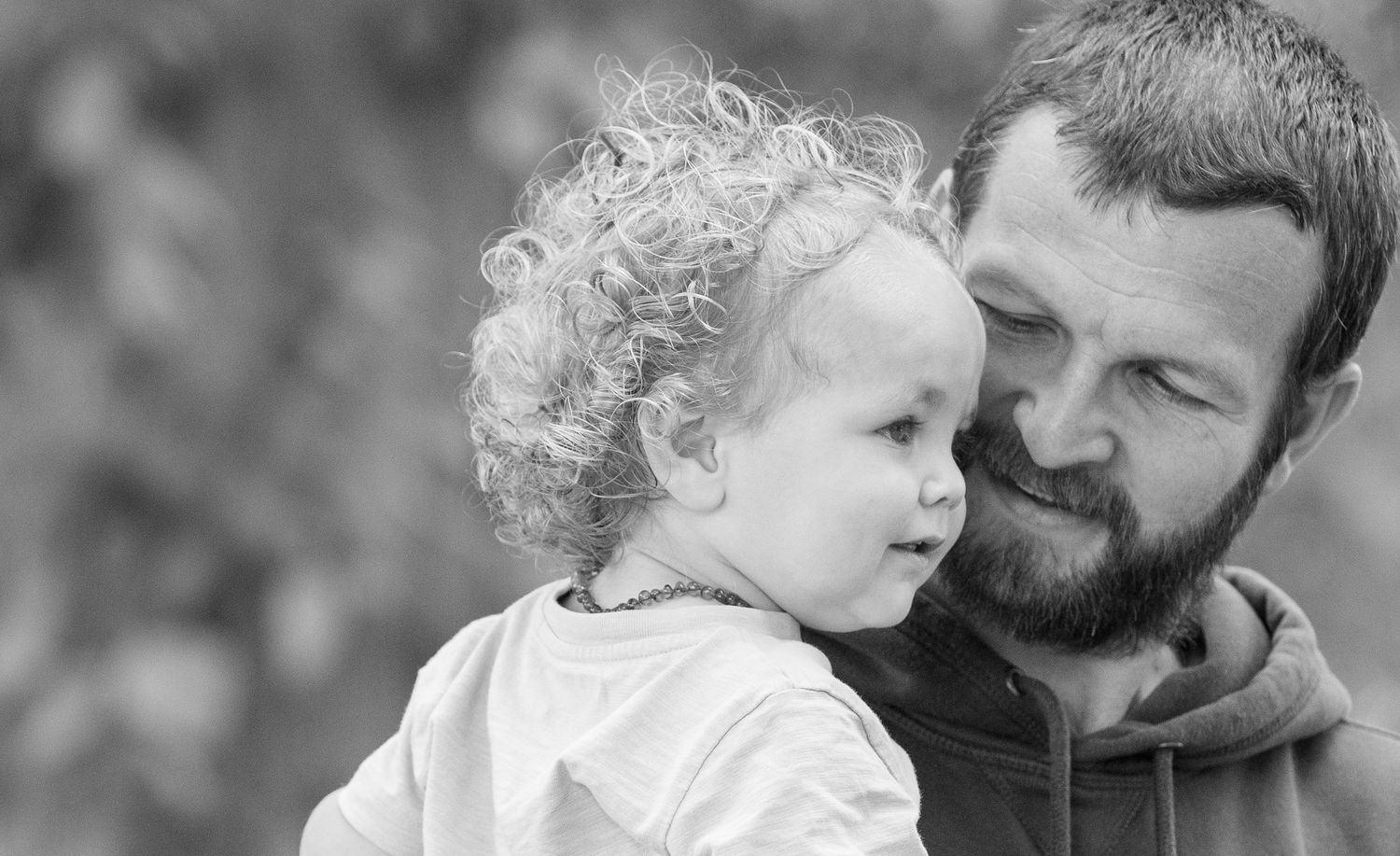 Black and white portrait series showing tender interactions between two people.