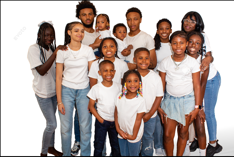 Large family group portrait of children and teens wearing matching white shirts and jeans on white background.