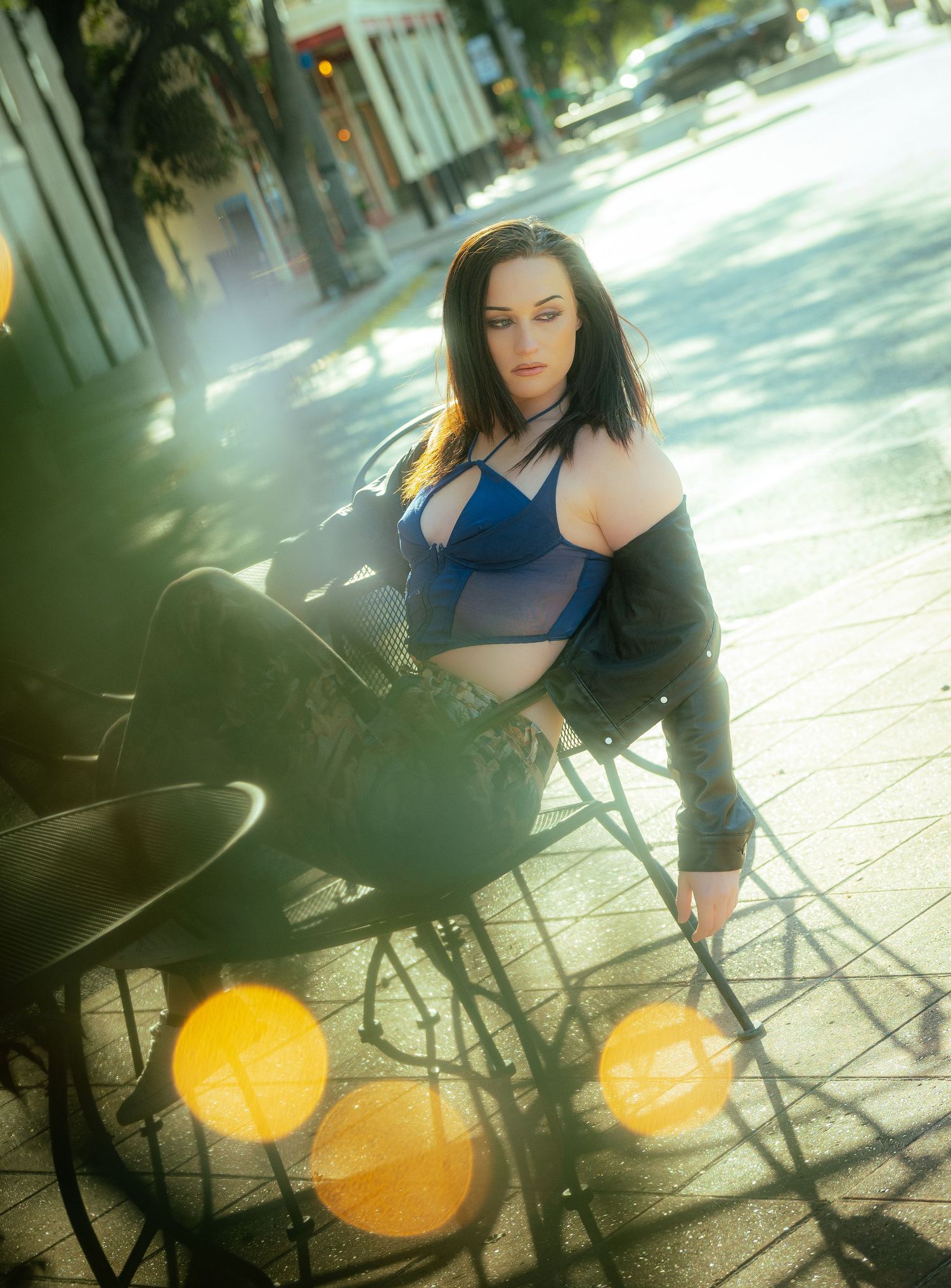 Stylish outdoor photoshoot with lens flare effects and urban elements.