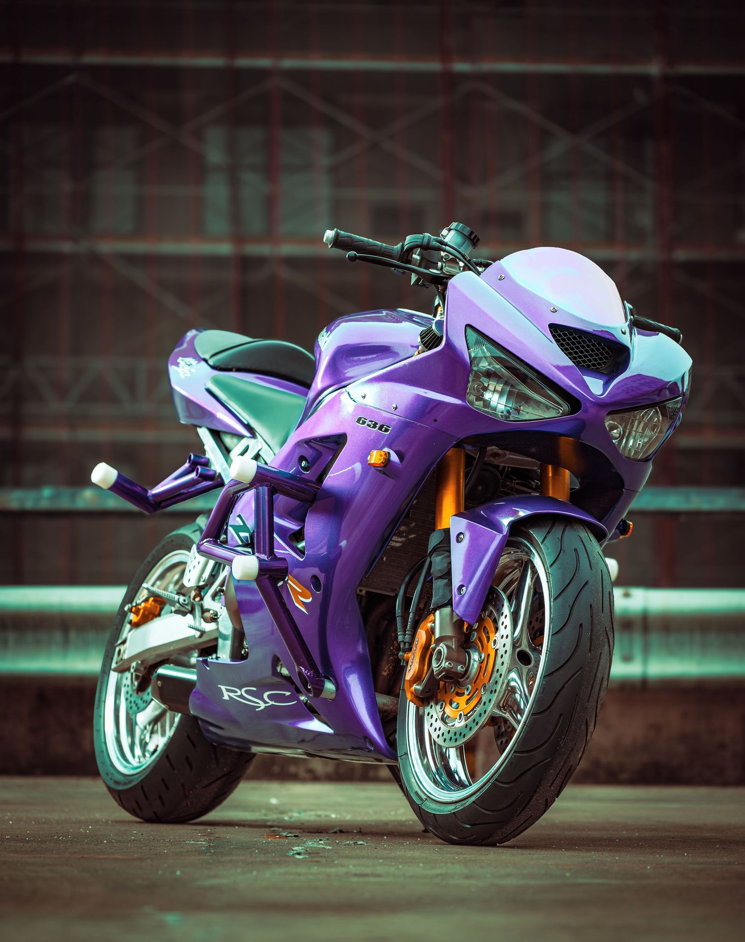 A sleek purple sport motorcycle shown from different angles against a dark background with dramatic lighting.