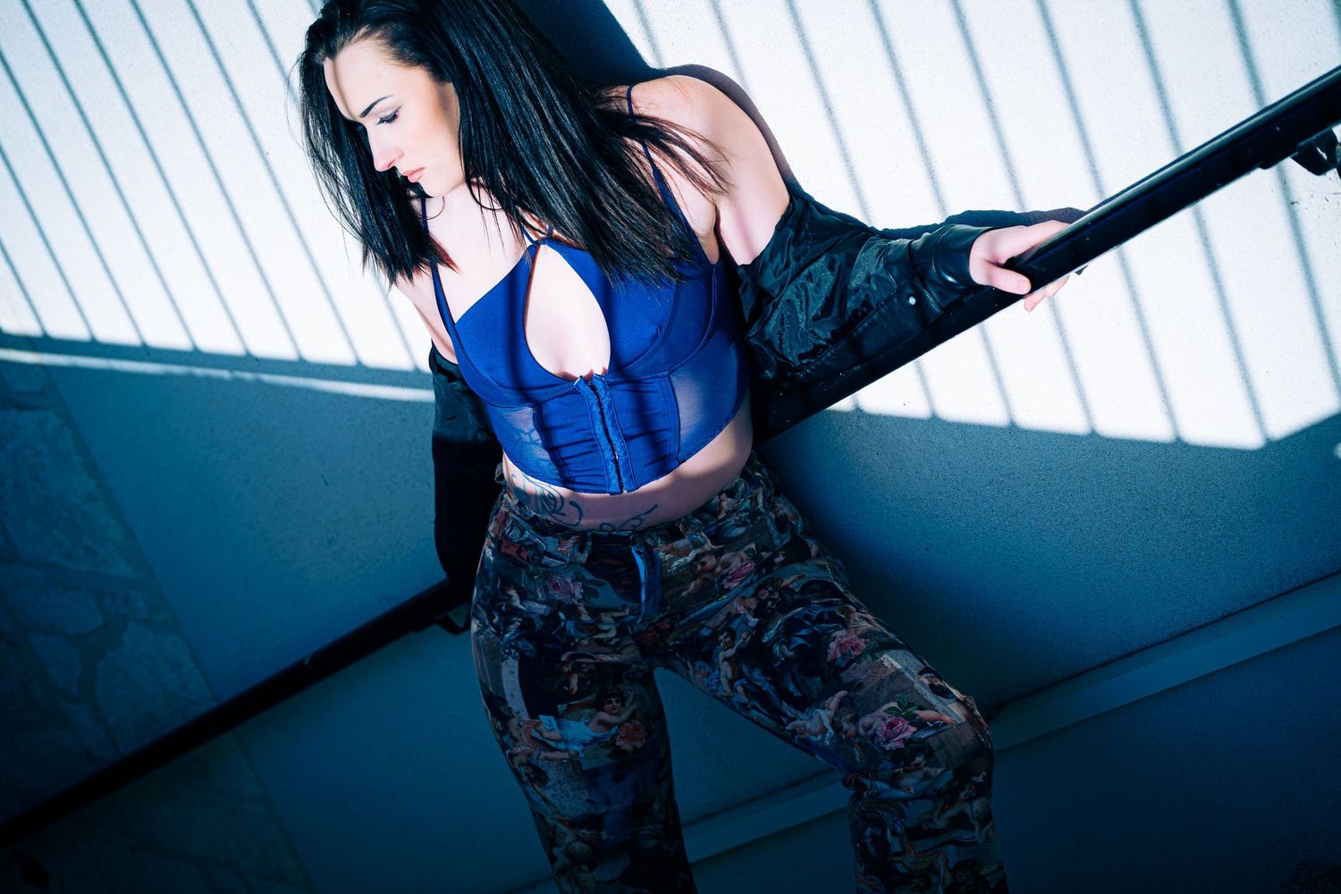 Indoor fashion series with dramatic lighting through window slats.