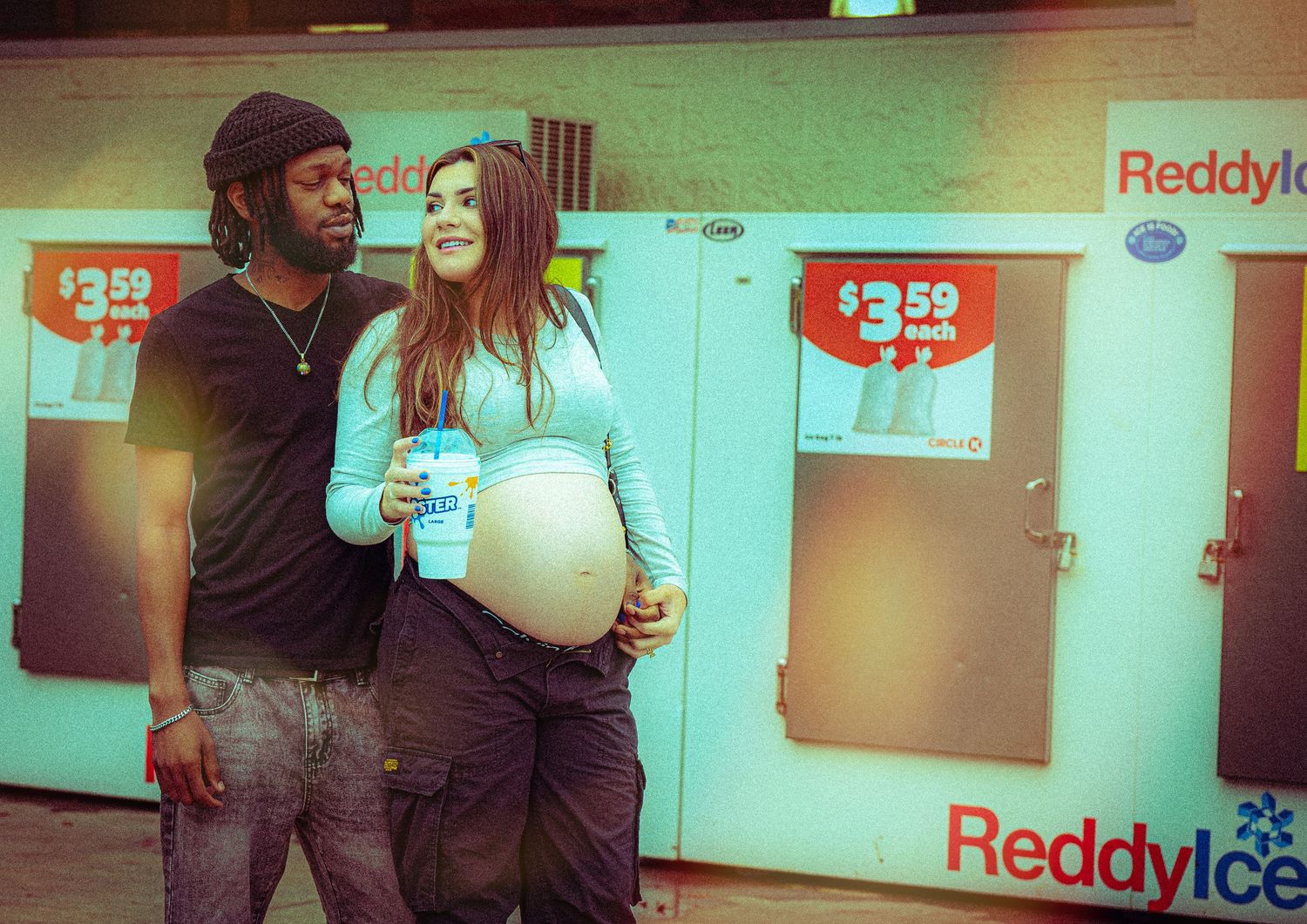 People photographed against a convenience store backdrop with Reddyice signage visible.