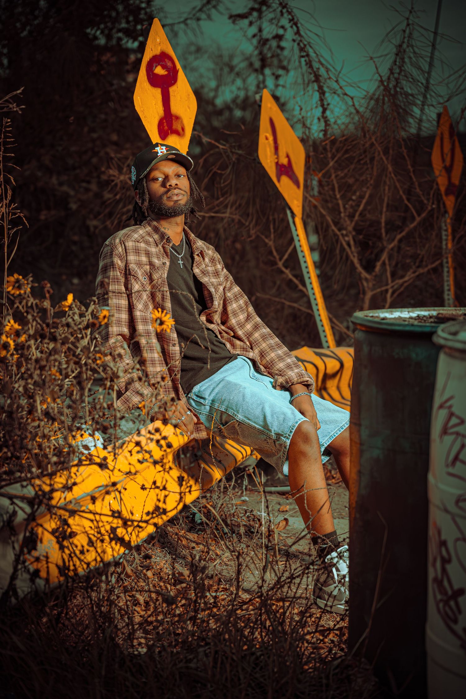 Artistic portrait series showing a person in autumn lighting with orange glow against dark foliage background.