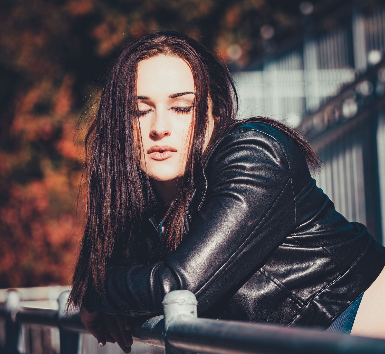 Fashion portraits with leather jacket against autumn-colored background.