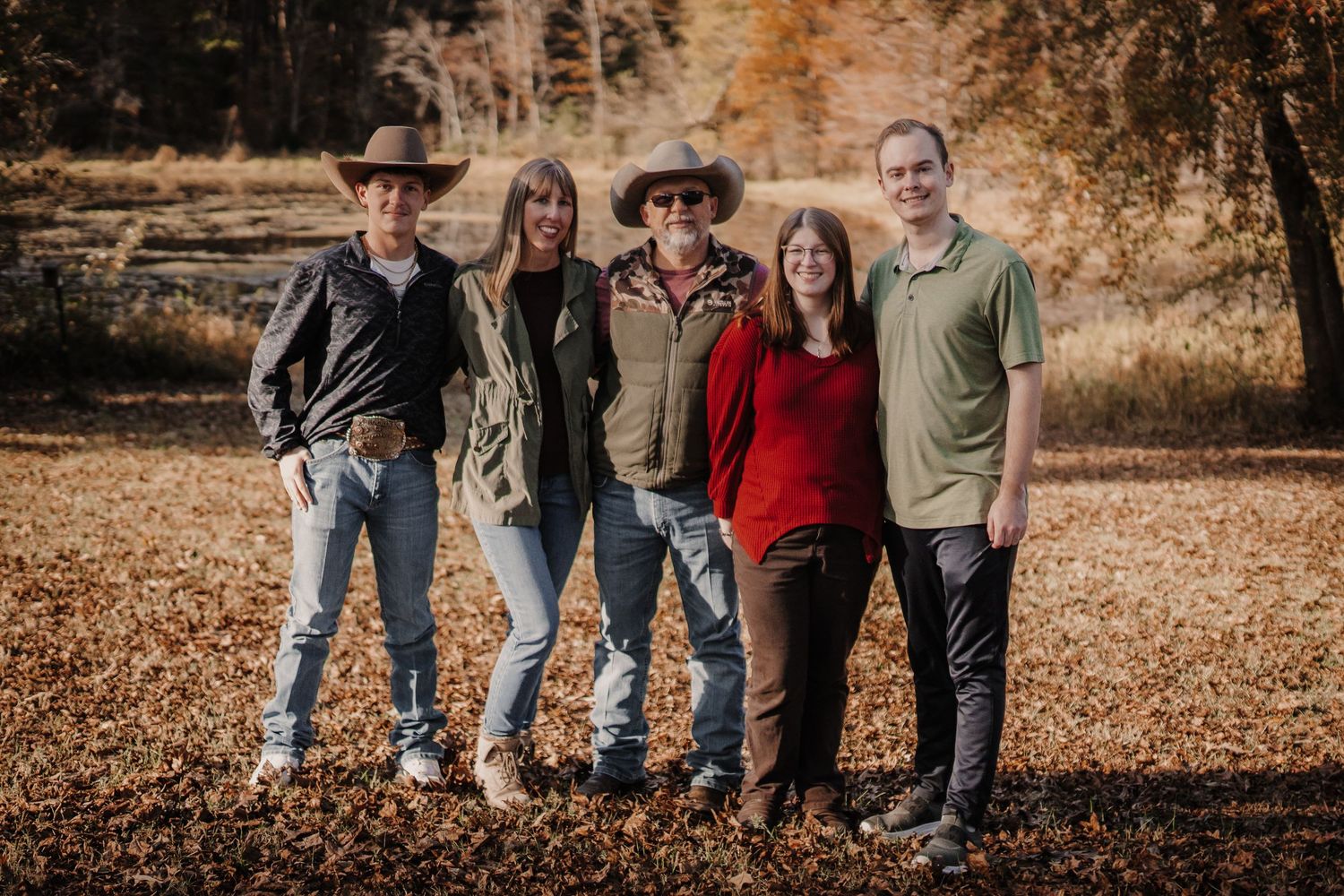 Family of five people in a fall setting.