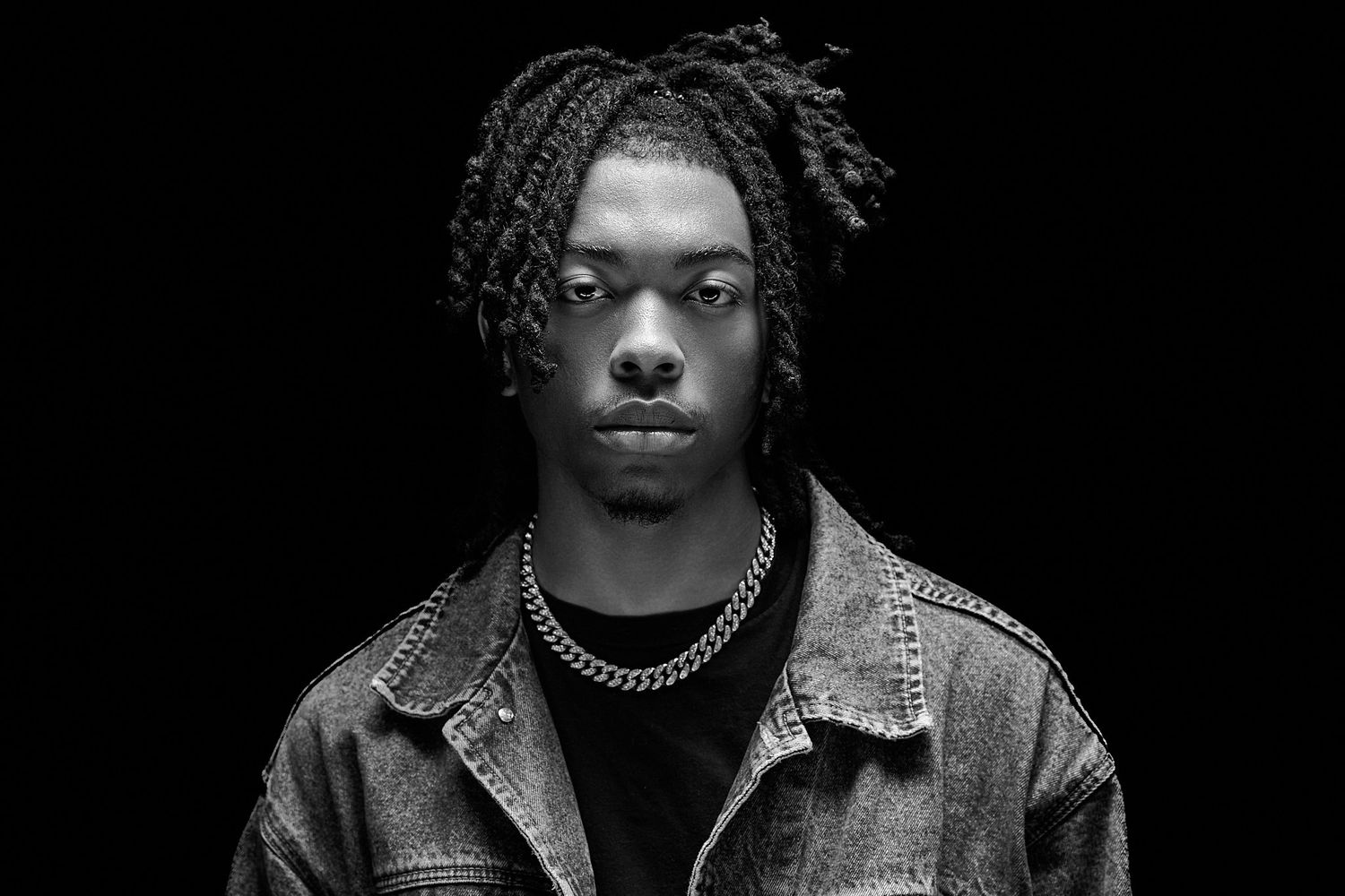 A series of black and white portrait photographs showing dramatic lighting and expressions against dark backgrounds.