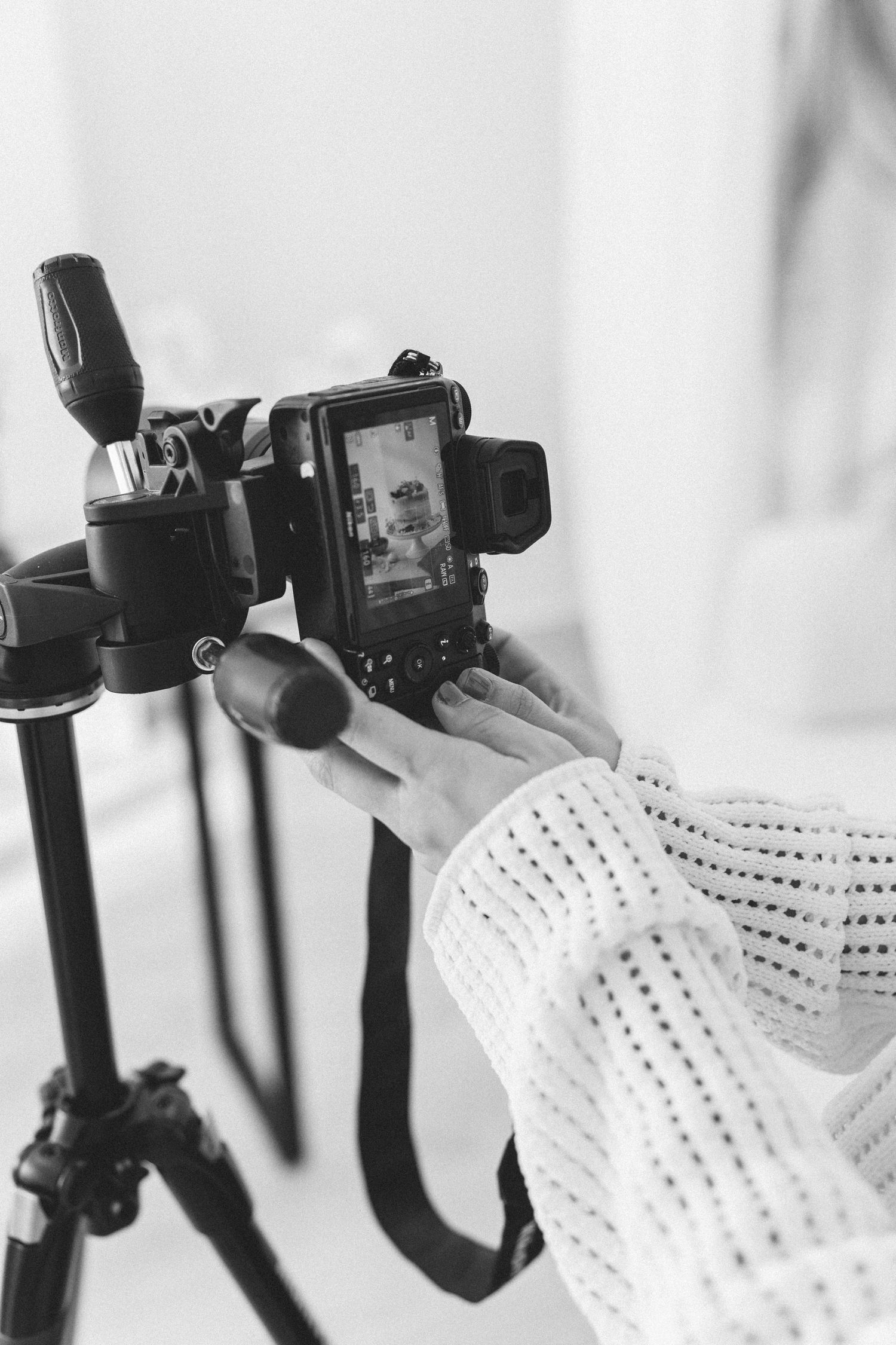 Professional camera equipment mounted on stabilizing rigs against white background.
