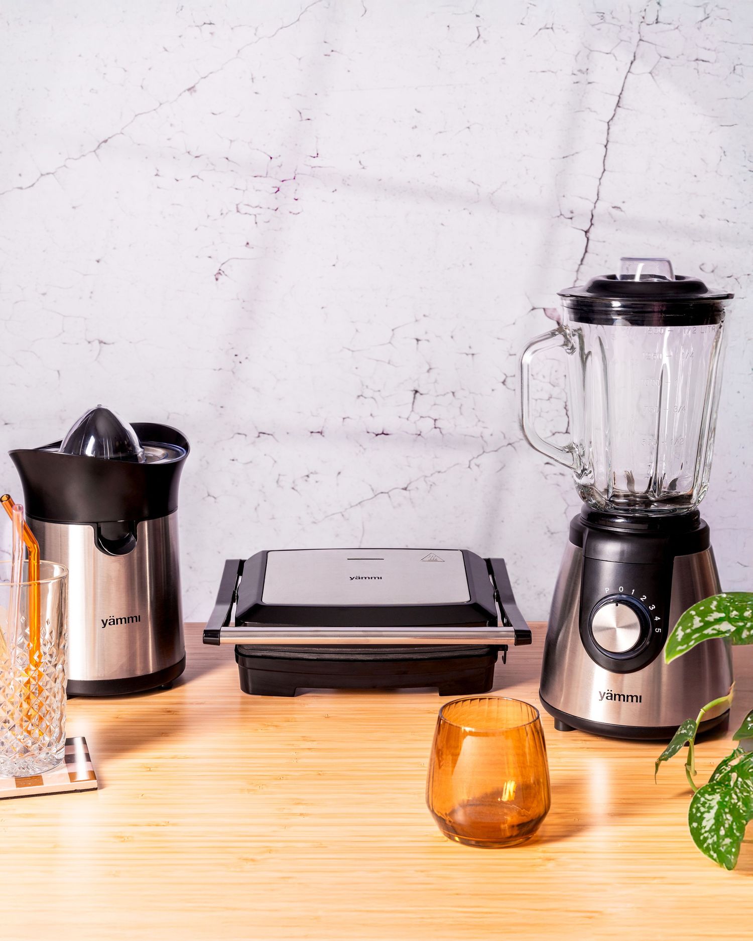 Kitchen counter with various modern appliances including blender and coffee maker.