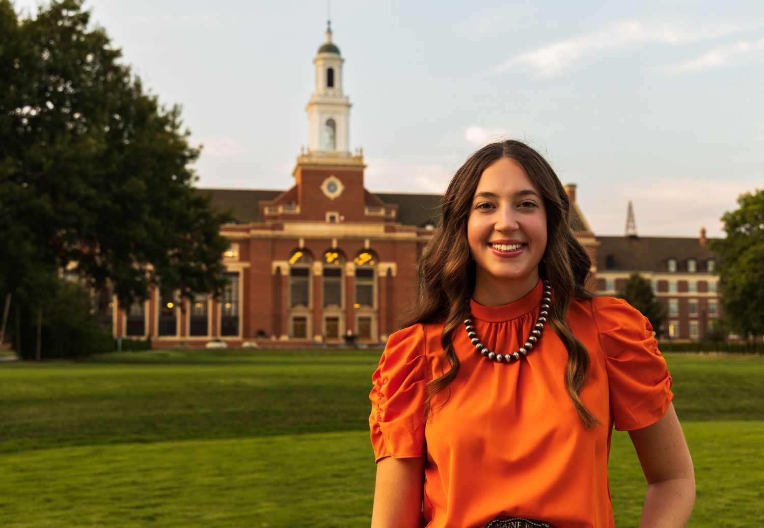 A girl standing in front of the Oklahoma State University library