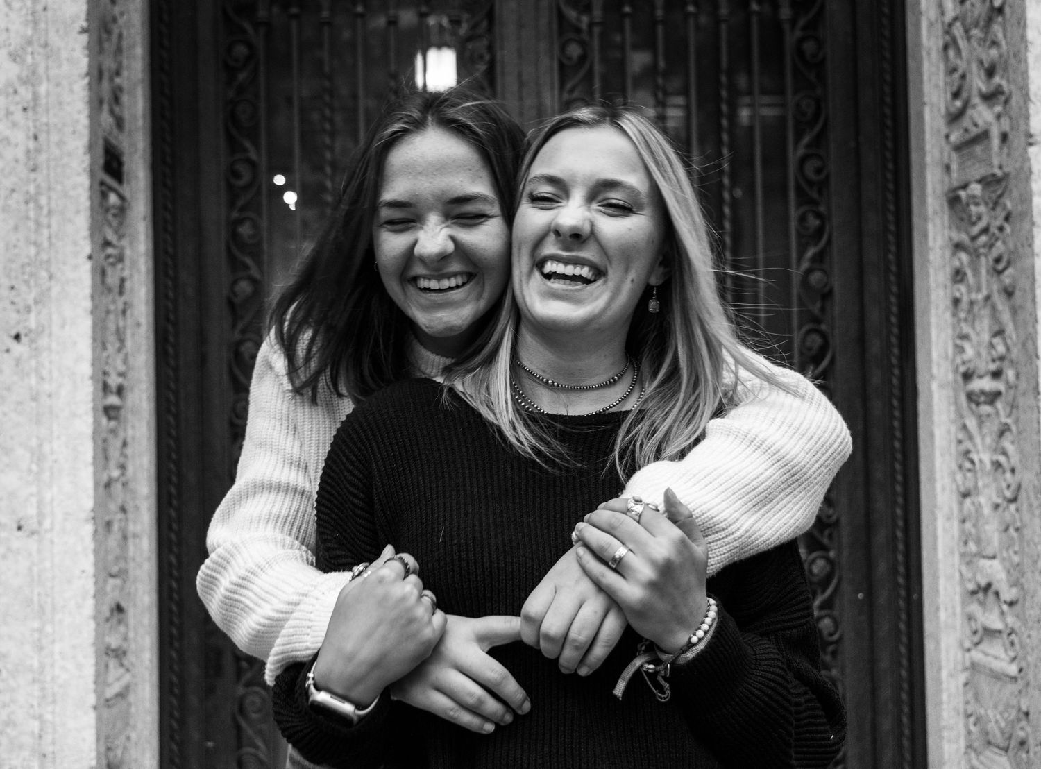 Two girls hugging and laughing.
