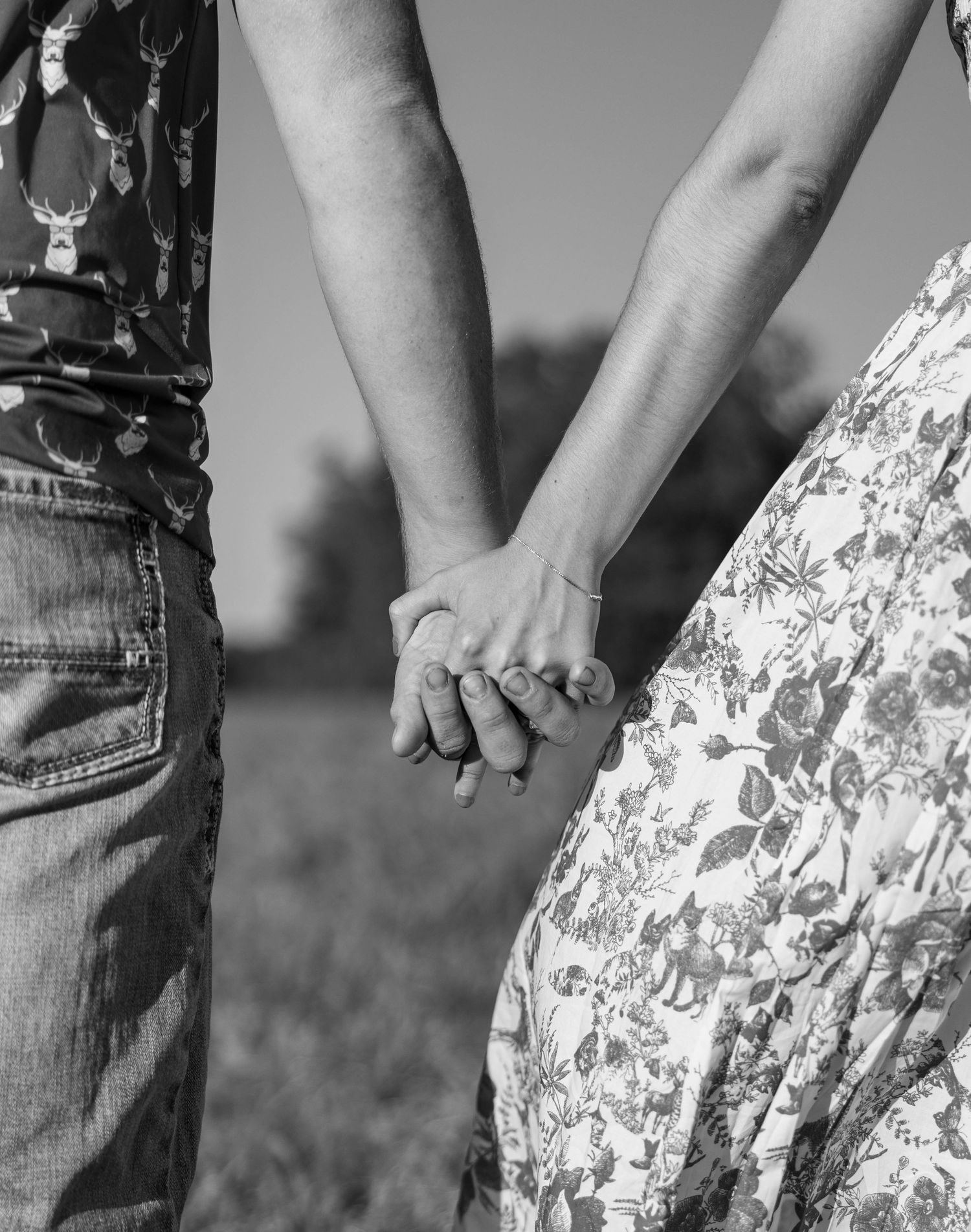 A close up photo of a couple holding hands.