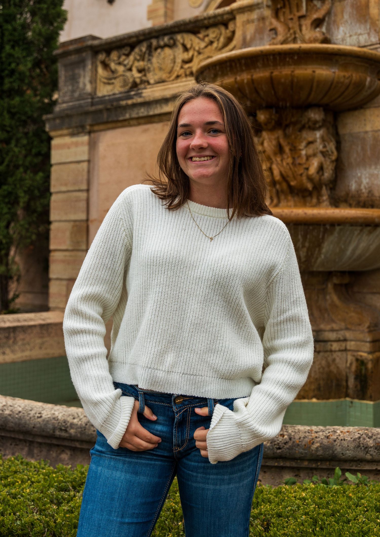 A girl standing and smiling.