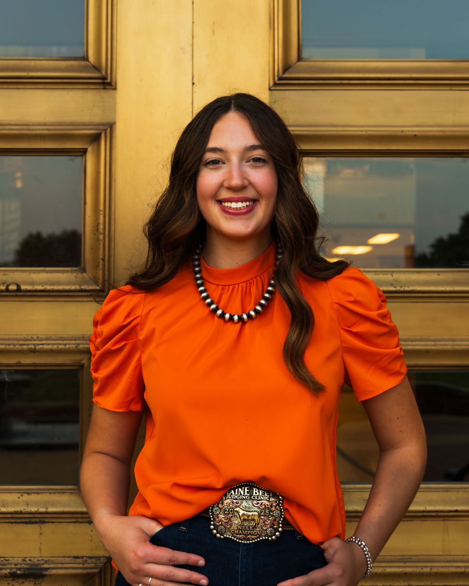 A girl standing in front of the Oklahoma State University library.
