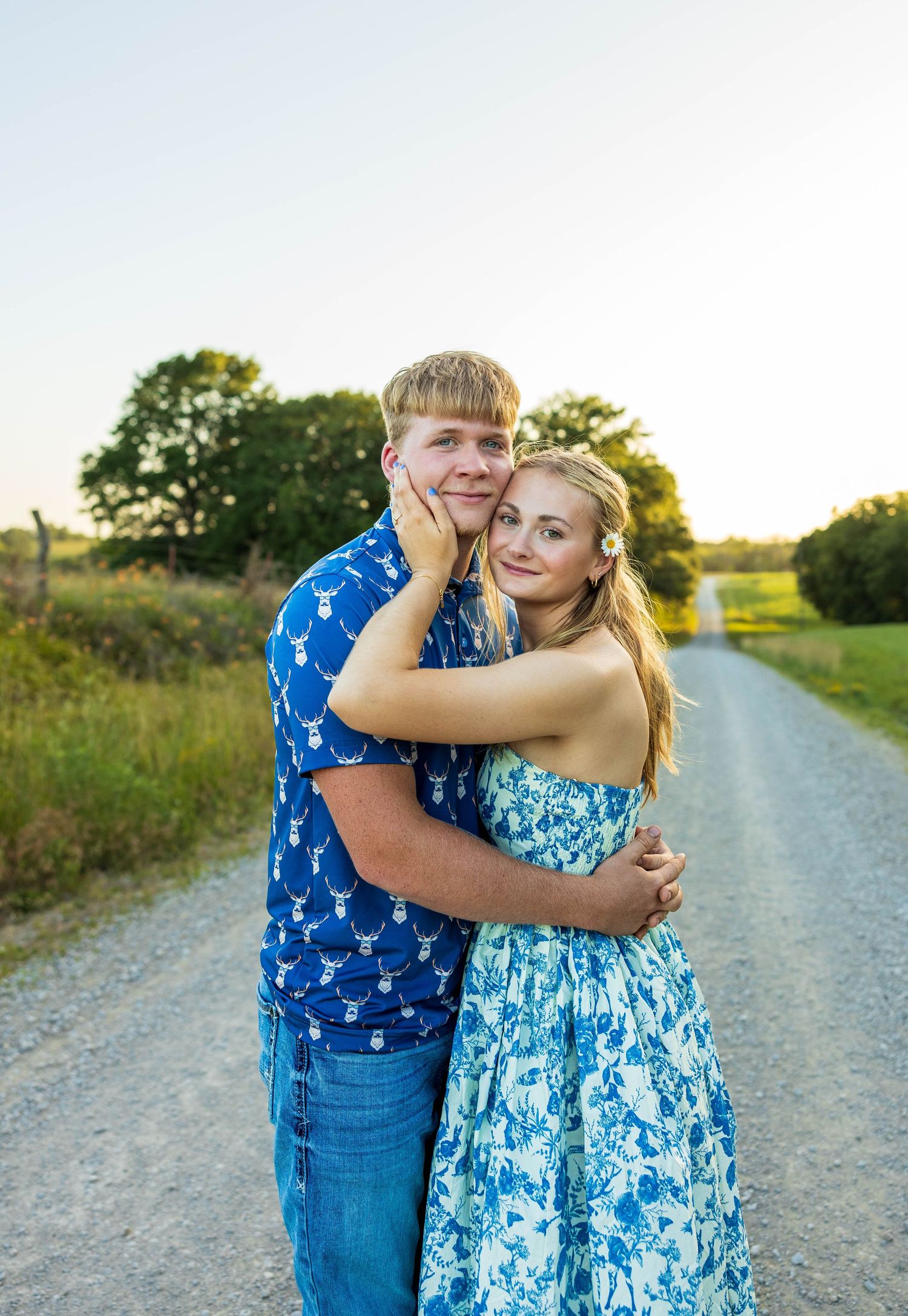 A couple hugging on a road.