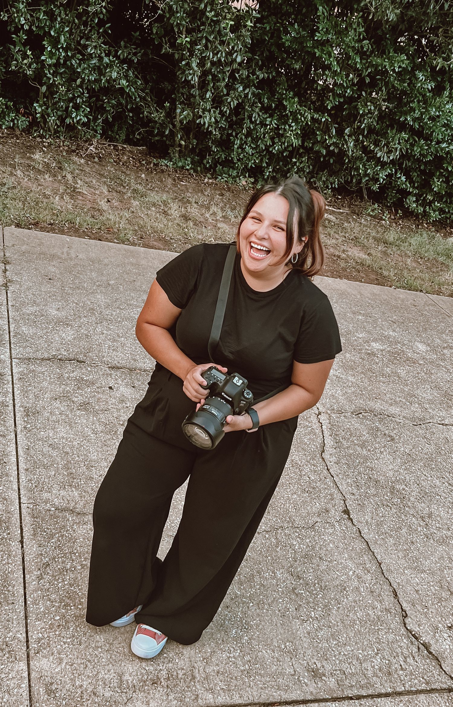 photographer laughing while holding professional camera